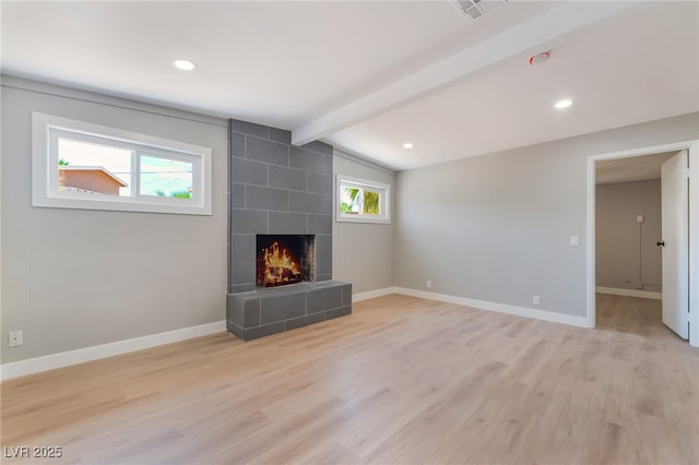 2749 Del Mar Pl, Las Vegas, NV 89169 - unfurnished living room featuring a tiled fireplace, light wood-style flooring, and recessed lighting