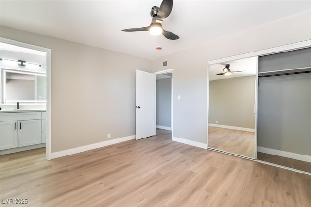 2749 Del Mar Pl, Las Vegas, NV 89169 - unfurnished bedroom featuring light wood-type flooring, ensuite bathroom, a closet, and a ceiling fan