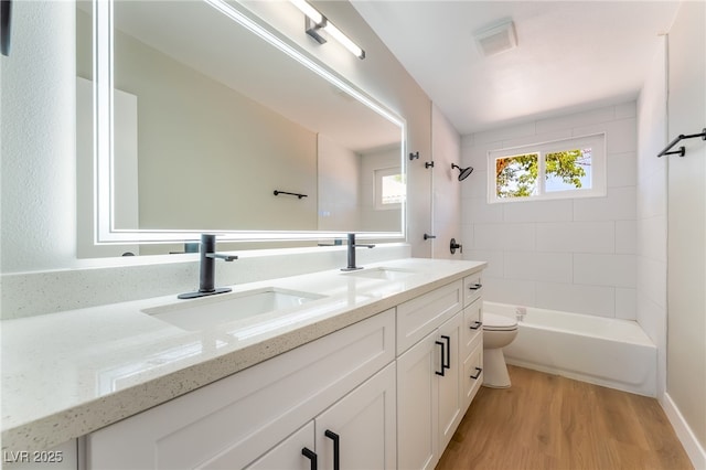 2749 Del Mar Pl, Las Vegas, NV 89169 - bathroom featuring double vanity, wood finished floors, and shower / bathtub combination