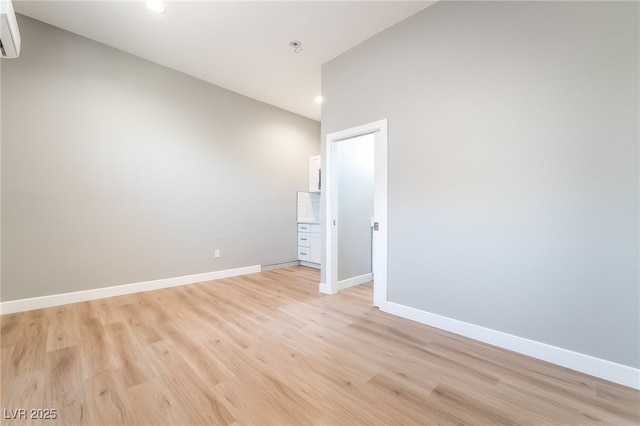 2749 Del Mar Pl, Las Vegas, NV 89169 - unfurnished room with recessed lighting, a wall mounted AC, light wood finished floors, and a pendent fire sprinkler