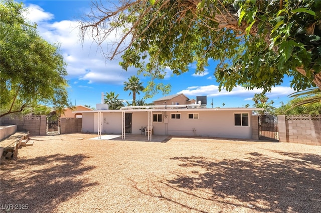 2749 Del Mar Pl, Las Vegas, NV 89169 - back of property with a gate, a patio area, and stucco siding