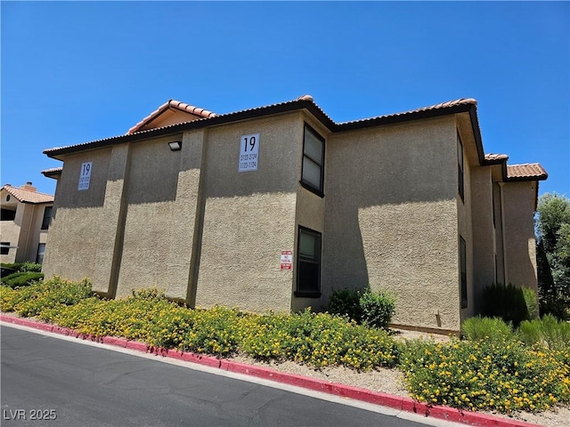 2451 N Rainbow Blvd Unit 1123, Las Vegas, NV 89108 - view of side of home with stucco siding and a tile roof