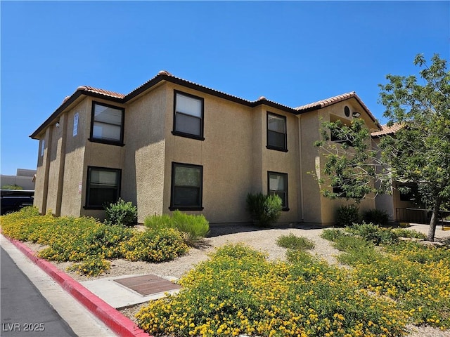 2451 N Rainbow Blvd Unit 1123, Las Vegas, NV 89108 - townhome / multi-family property with stucco siding and a tiled roof
