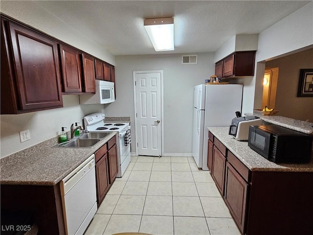 2451 N Rainbow Blvd Unit 1123, Las Vegas, NV 89108 - kitchen with white appliances, light tile patterned floors, and a textured ceiling