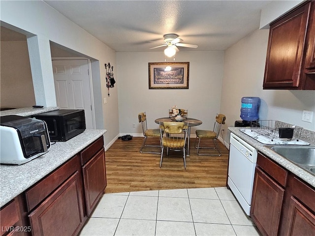 2451 N Rainbow Blvd Unit 1123, Las Vegas, NV 89108 - kitchen with white dishwasher, a ceiling fan, light countertops, light tile patterned floors, and black microwave