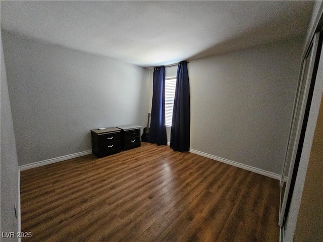 2451 N Rainbow Blvd Unit 1123, Las Vegas, NV 89108 - empty room featuring dark wood-type flooring and baseboards