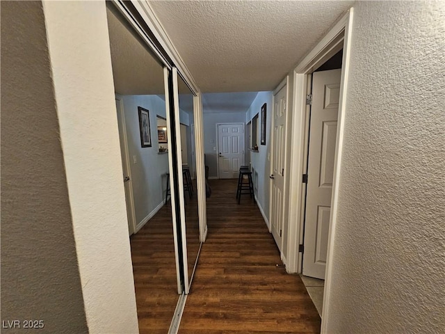 2451 N Rainbow Blvd Unit 1123, Las Vegas, NV 89108 - hall featuring a textured wall, dark wood-style flooring, and a textured ceiling