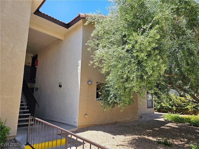 2451 N Rainbow Blvd Unit 1123, Las Vegas, NV 89108 - view of side of property featuring stairway, stucco siding, and a tile roof
