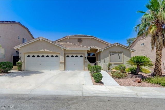 9632 Cherry Canyon Ave, Las Vegas, NV 89129 - mediterranean / spanish-style home featuring a garage, stucco siding, concrete driveway, and a tile roof