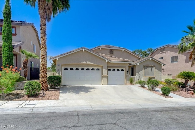 9632 Cherry Canyon Ave, Las Vegas, NV 89129 - mediterranean / spanish-style home featuring an attached garage, stucco siding, concrete driveway, and a tile roof