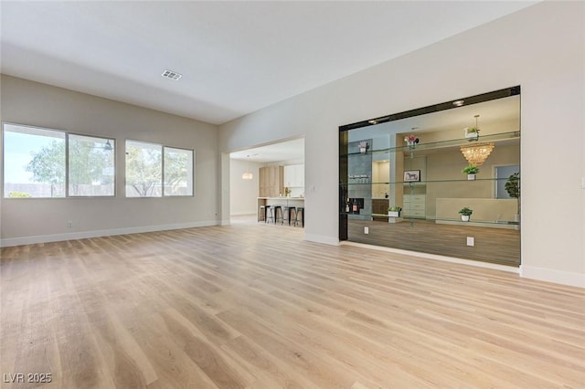 9632 Cherry Canyon Ave, Las Vegas, NV 89129 - unfurnished living room with wood finished floors and a chandelier