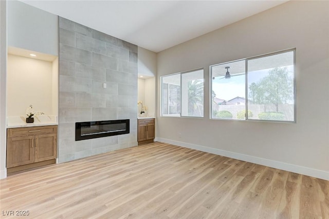 9632 Cherry Canyon Ave, Las Vegas, NV 89129 - unfurnished living room with light wood-style floors and a tiled fireplace