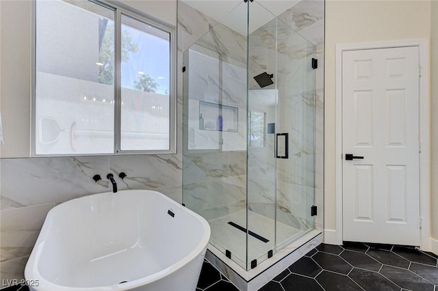 9632 Cherry Canyon Ave, Las Vegas, NV 89129 - bathroom with a freestanding tub, a marble finish shower, tile walls, and tile patterned flooring