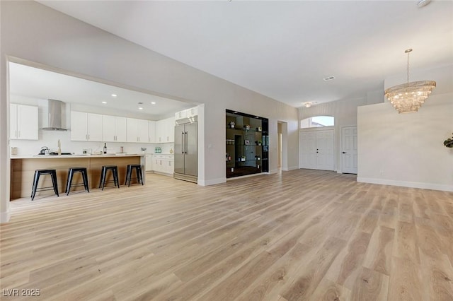 9632 Cherry Canyon Ave, Las Vegas, NV 89129 - unfurnished living room with light wood-style floors and a chandelier