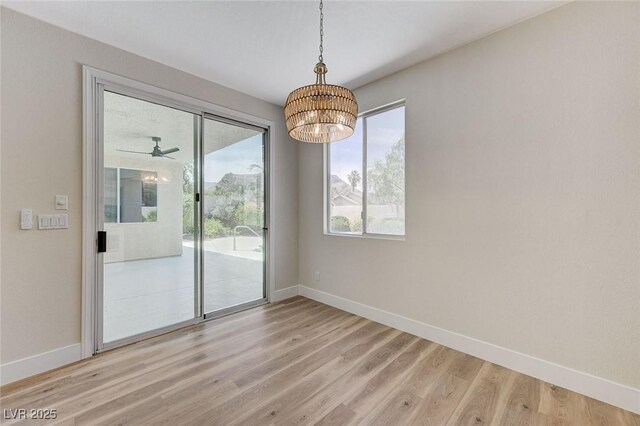 9632 Cherry Canyon Ave, Las Vegas, NV 89129 - unfurnished room with a chandelier, plenty of natural light, and light wood finished floors