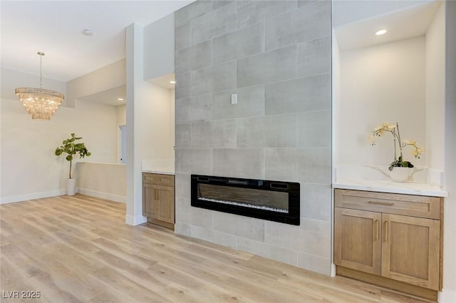9632 Cherry Canyon Ave, Las Vegas, NV 89129 - unfurnished living room with a tile fireplace, light wood finished floors, a chandelier, and recessed lighting