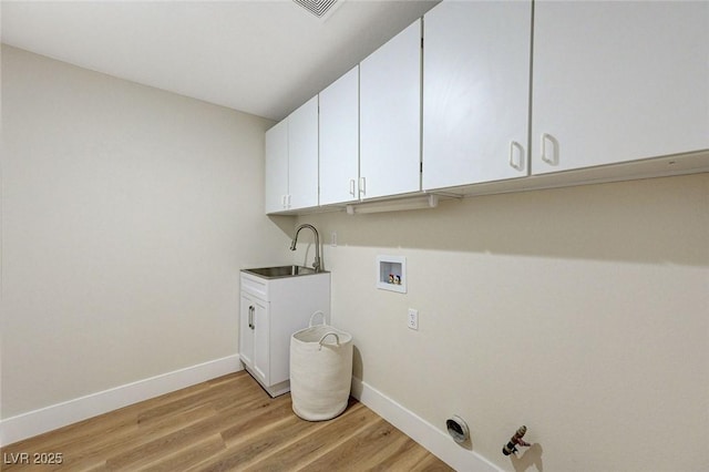 9632 Cherry Canyon Ave, Las Vegas, NV 89129 - laundry area featuring hookup for a gas dryer, hookup for a washing machine, light wood-style floors, and cabinet space