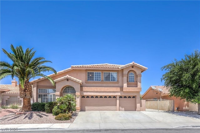 2728 Aspen Wood Ave, Henderson, NV 89074 - mediterranean / spanish home with concrete driveway, stucco siding, an attached garage, and a tile roof