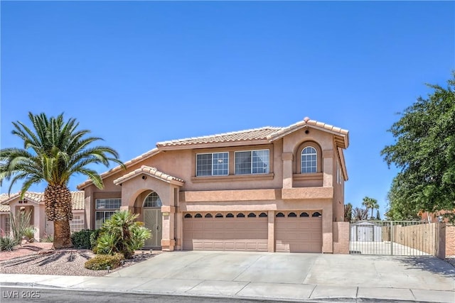 2728 Aspen Wood Ave, Henderson, NV 89074 - mediterranean / spanish-style home with stucco siding, a gate, driveway, and an attached garage