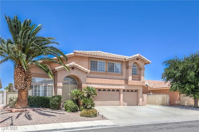 2728 Aspen Wood Ave, Henderson, NV 89074 - mediterranean / spanish-style house featuring an attached garage, stucco siding, driveway, and a tile roof