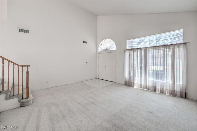 2728 Aspen Wood Ave, Henderson, NV 89074 - entryway with a towering ceiling, plenty of natural light, carpet floors, and stairs