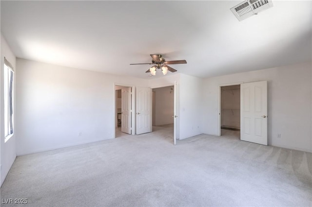 2728 Aspen Wood Ave, Henderson, NV 89074 - unfurnished bedroom featuring a walk in closet, light carpet, a ceiling fan, and a closet