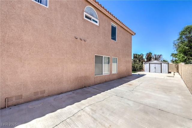 2728 Aspen Wood Ave, Henderson, NV 89074 - view of side of home featuring a storage unit, a patio, and stucco siding