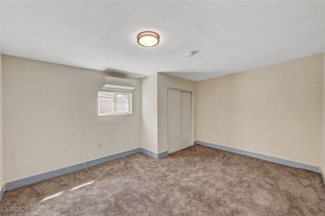 1804 David Ave, Las Vegas, NV 89101 - unfurnished bedroom with a wall mounted AC, carpet, a closet, and a textured ceiling