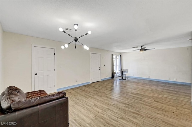 1804 David Ave, Las Vegas, NV 89101 - unfurnished living room featuring a chandelier, light wood finished floors, and a ceiling fan