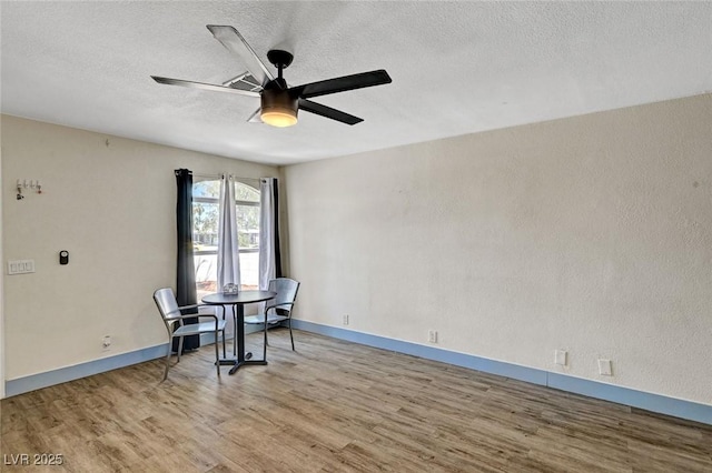 1804 David Ave, Las Vegas, NV 89101 - unfurnished dining area featuring wood finished floors, ceiling fan, and a textured ceiling