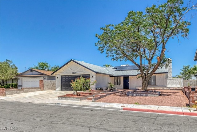 6808 Waterhen Cir, Las Vegas, NV 89108 - ranch-style house featuring an attached garage, roof mounted solar panels, and concrete driveway