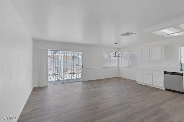 6808 Waterhen Cir, Las Vegas, NV 89108 - unfurnished dining area featuring a chandelier and wood finished floors