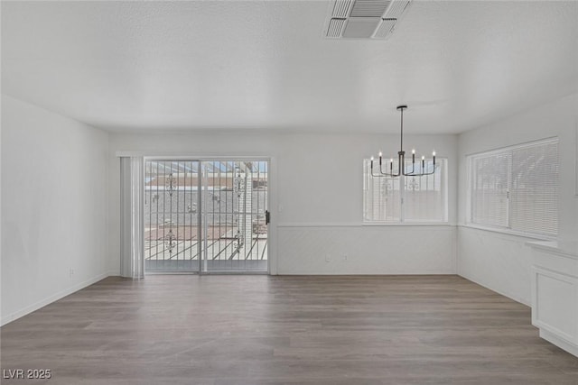 6808 Waterhen Cir, Las Vegas, NV 89108 - unfurnished dining area with a chandelier and wood finished floors
