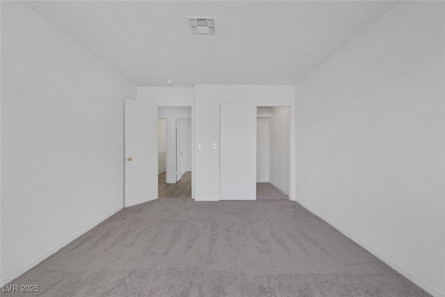 6808 Waterhen Cir, Las Vegas, NV 89108 - unfurnished bedroom with carpet flooring, a textured ceiling, and a closet