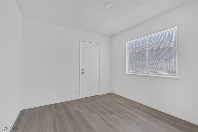 6808 Waterhen Cir, Las Vegas, NV 89108 - spare room with a textured ceiling and wood finished floors