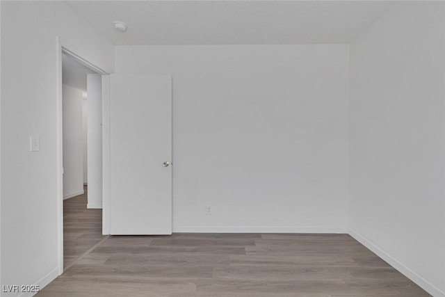 6808 Waterhen Cir, Las Vegas, NV 89108 - unfurnished bedroom with baseboards and wood finished floors
