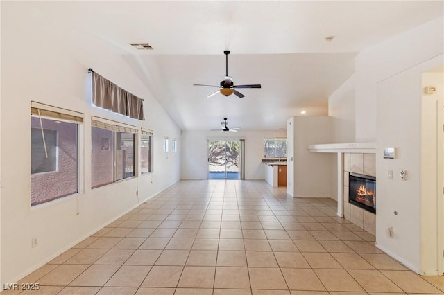 4043 Lilac Creek Ct, Las Vegas, NV 89122 - unfurnished living room with a ceiling fan, vaulted ceiling, a tile fireplace, and light tile patterned floors