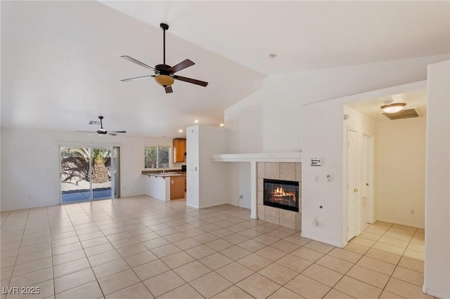 4043 Lilac Creek Ct, Las Vegas, NV 89122 - unfurnished living room with lofted ceiling, a ceiling fan, light tile patterned floors, and a fireplace