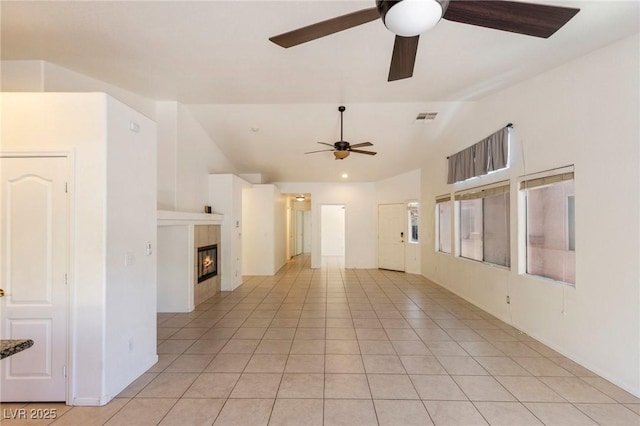 4043 Lilac Creek Ct, Las Vegas, NV 89122 - unfurnished room with a ceiling fan, vaulted ceiling, a tile fireplace, and light tile patterned flooring