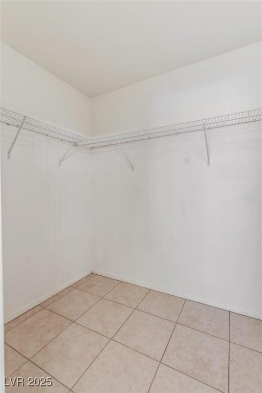 4043 Lilac Creek Ct, Las Vegas, NV 89122 - walk in closet featuring light tile patterned flooring