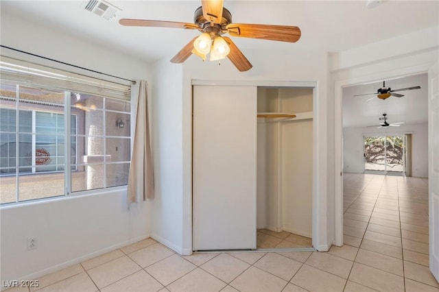 4043 Lilac Creek Ct, Las Vegas, NV 89122 - unfurnished bedroom with light tile patterned floors, a closet, and ceiling fan