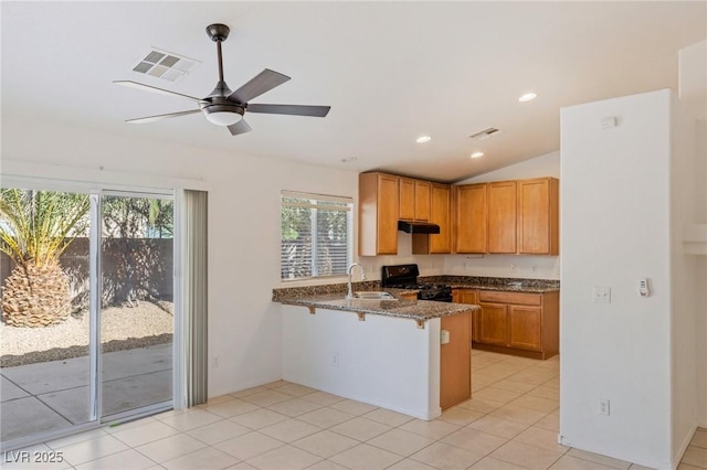 4043 Lilac Creek Ct, Las Vegas, NV 89122 - kitchen featuring black gas range oven, a peninsula, under cabinet range hood, dark stone countertops, and ceiling fan