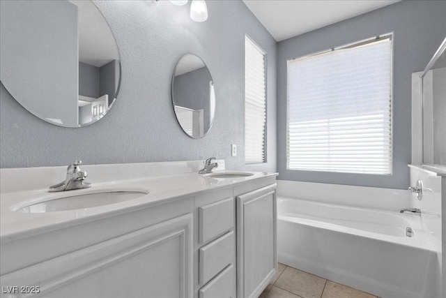 7818 Brodie Castle Ct, Las Vegas, NV 89166 - bathroom featuring a bath, double vanity, and tile patterned floors