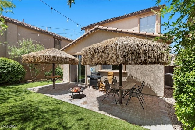7818 Brodie Castle Ct, Las Vegas, NV 89166 - fenced backyard featuring a fire pit, grilling area, and a patio area