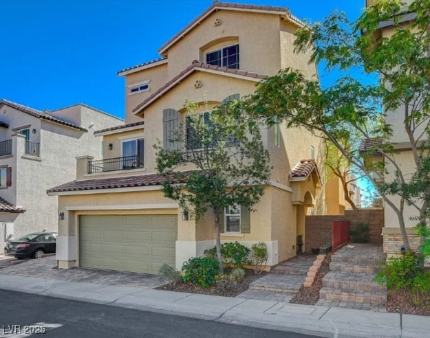 10725 Wrigley Field Ave, Las Vegas, NV 89166 - mediterranean / spanish-style home with stucco siding, a tiled roof, an attached garage, and driveway