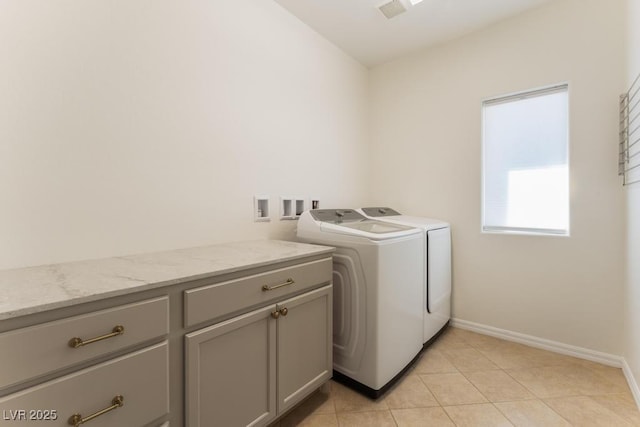 5735 Oak Bend Dr, Las Vegas, NV 89135 - washroom with washing machine and clothes dryer, cabinet space, and light tile patterned floors