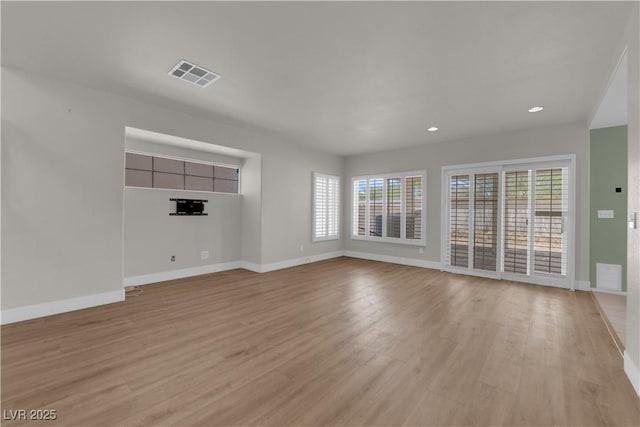 638 Ribbon Grass Ave, Las Vegas, NV 89183 - unfurnished living room with light wood-style floors and recessed lighting