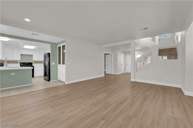 638 Ribbon Grass Ave, Las Vegas, NV 89183 - unfurnished living room featuring light wood finished floors and recessed lighting