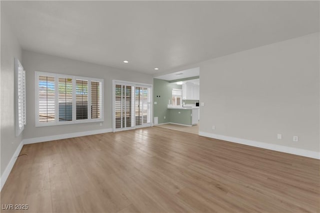 638 Ribbon Grass Ave, Las Vegas, NV 89183 - unfurnished living room with light wood-type flooring and recessed lighting
