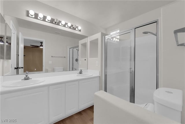 638 Ribbon Grass Ave, Las Vegas, NV 89183 - full bath featuring a shower stall, double vanity, wood finished floors, and a ceiling fan